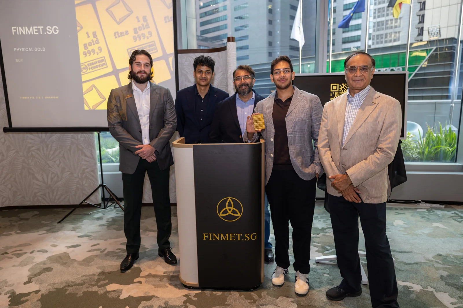 Five people standing beside the FinMet.sg launch podium