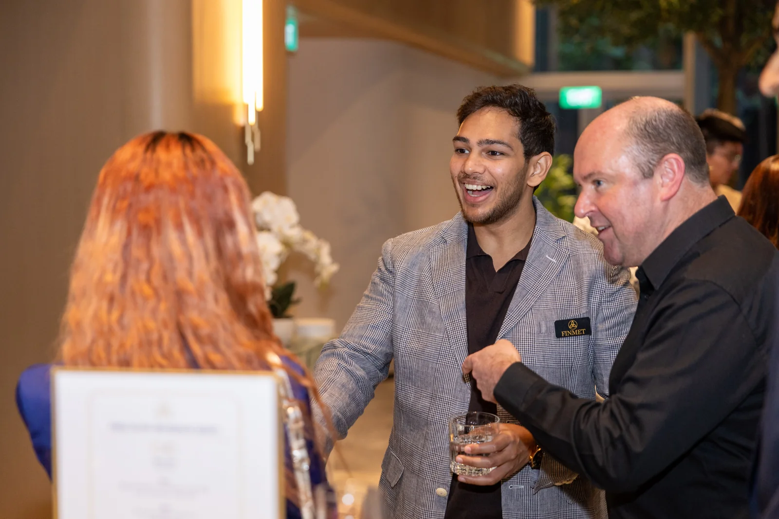 Guests sharing a smile during a conversation at the FinMet.sg launch